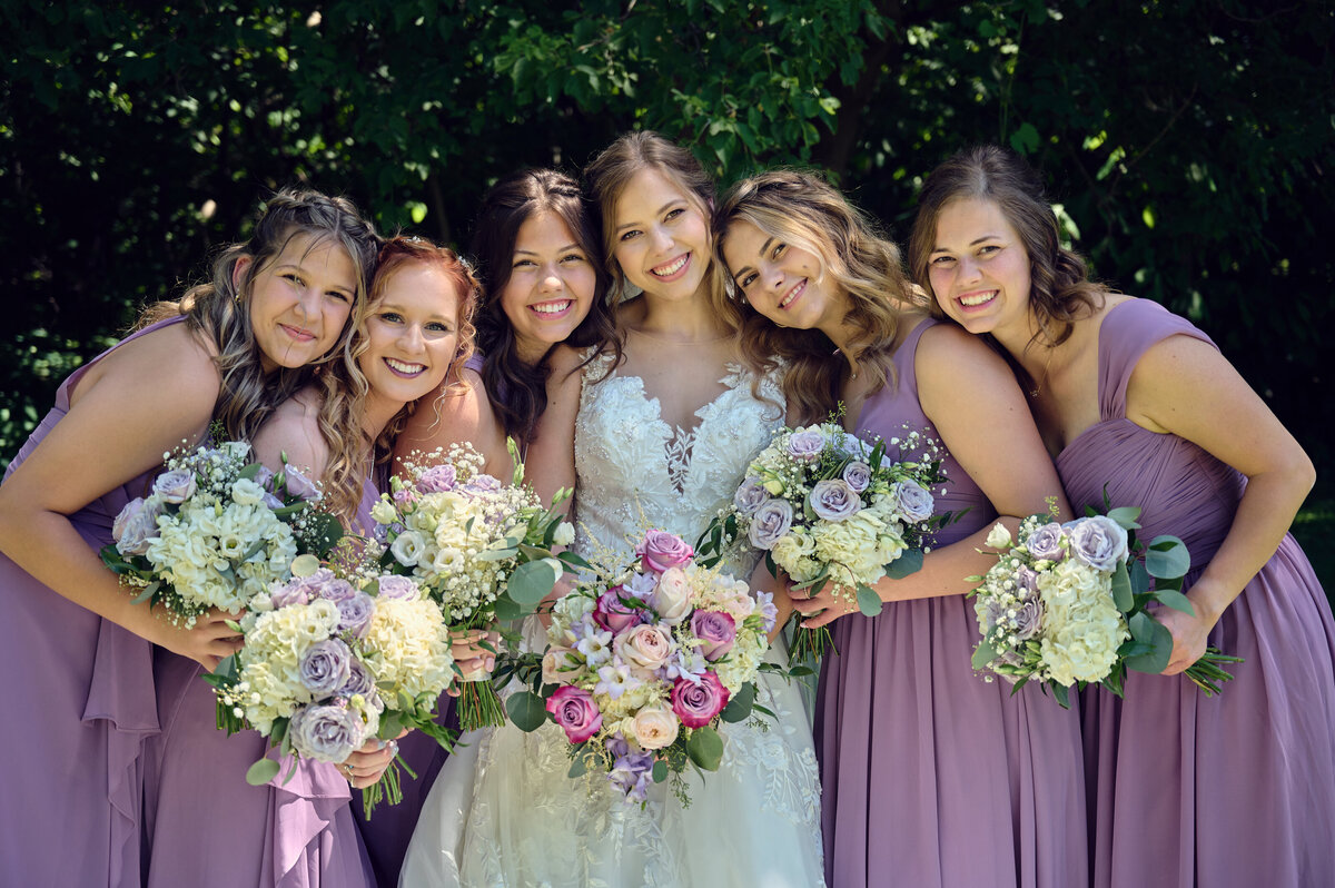 Bride and Bridesmaids cuddling in together at Dodge Park in Clinton Township, Michigan
