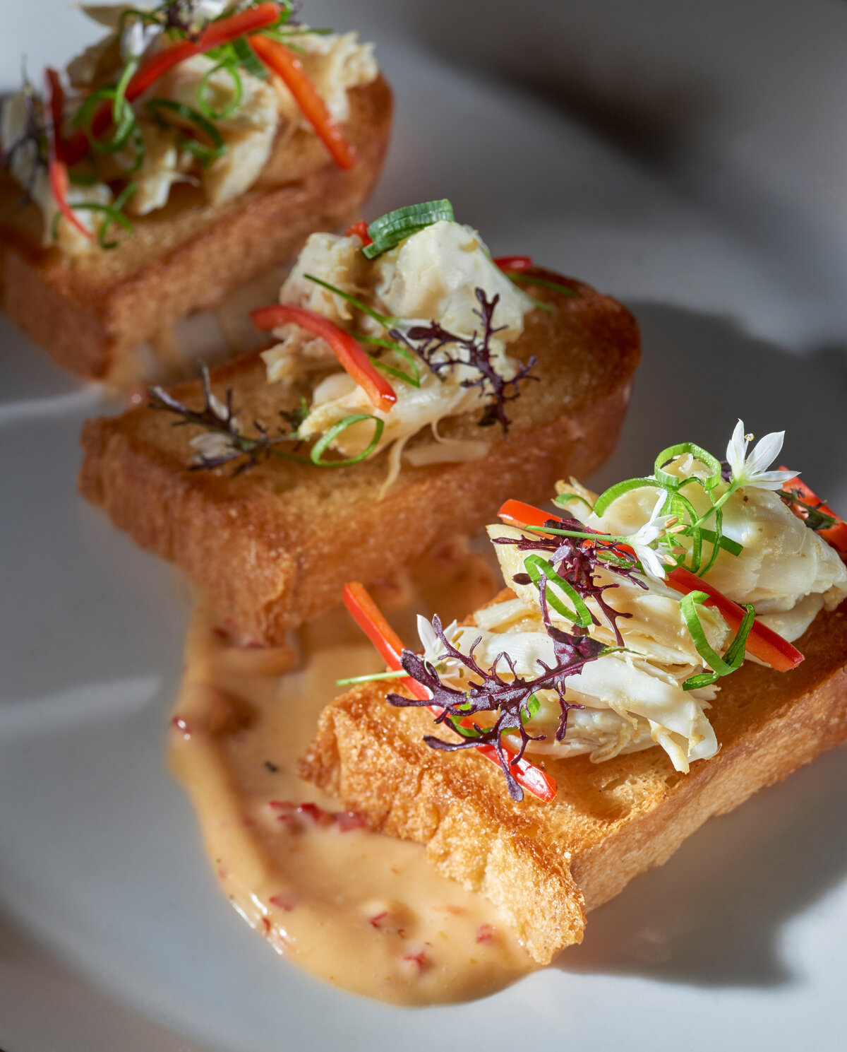 Slaw on top of small pieces of bread