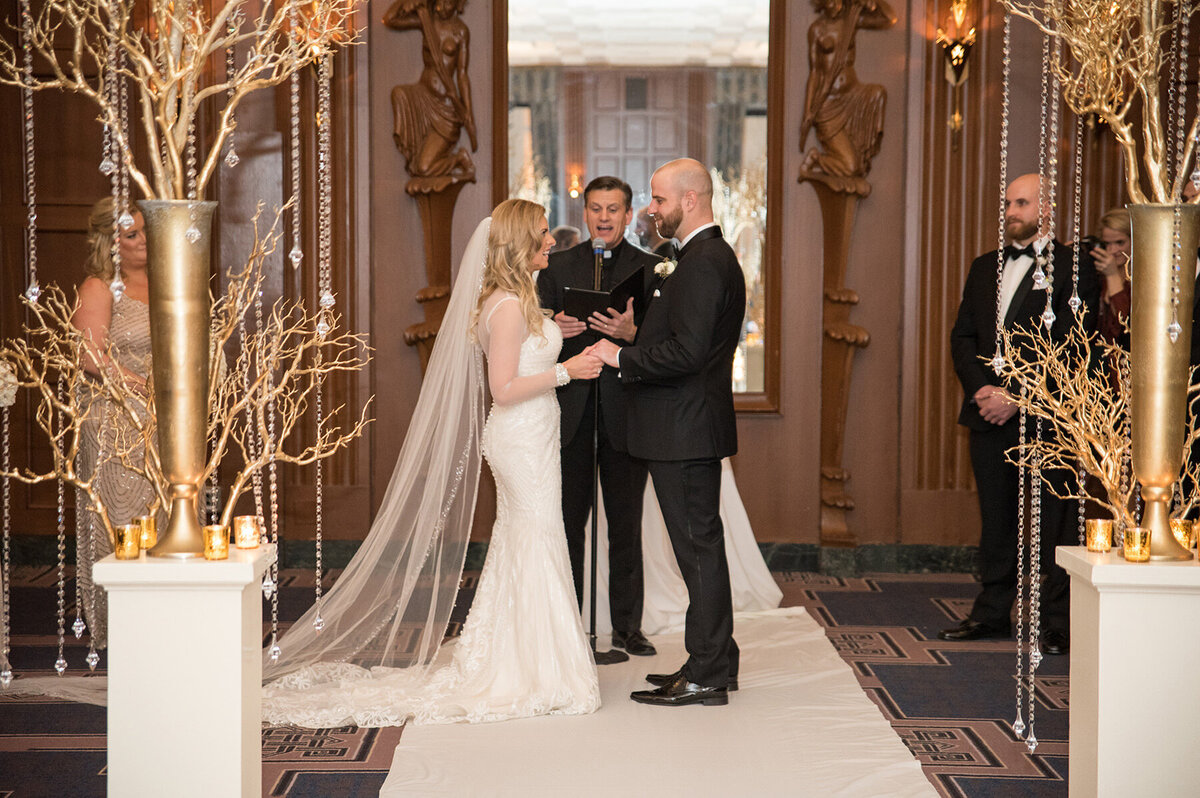 Glamorous bride and groom take their wedding vows