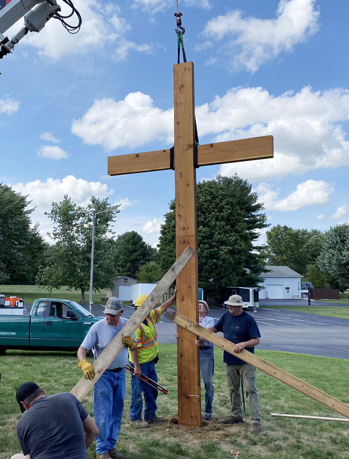 The men's service group installs a cross outside at Bartlett Chapel.