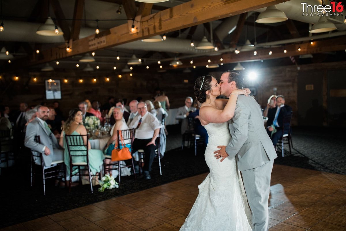 Bride and Groom share a kiss during their first dance