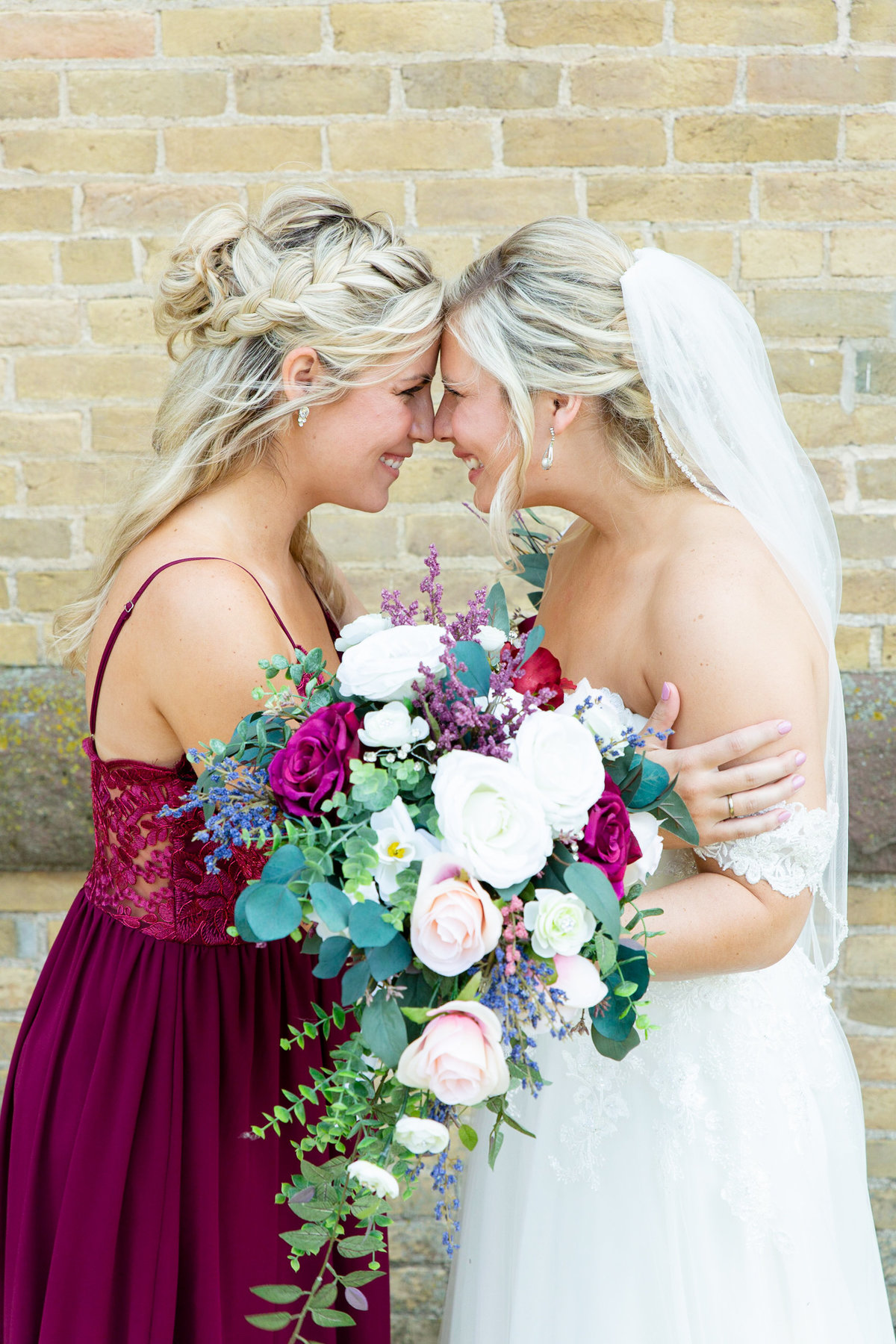Sisters, bride and matron of honor share moment before wedding