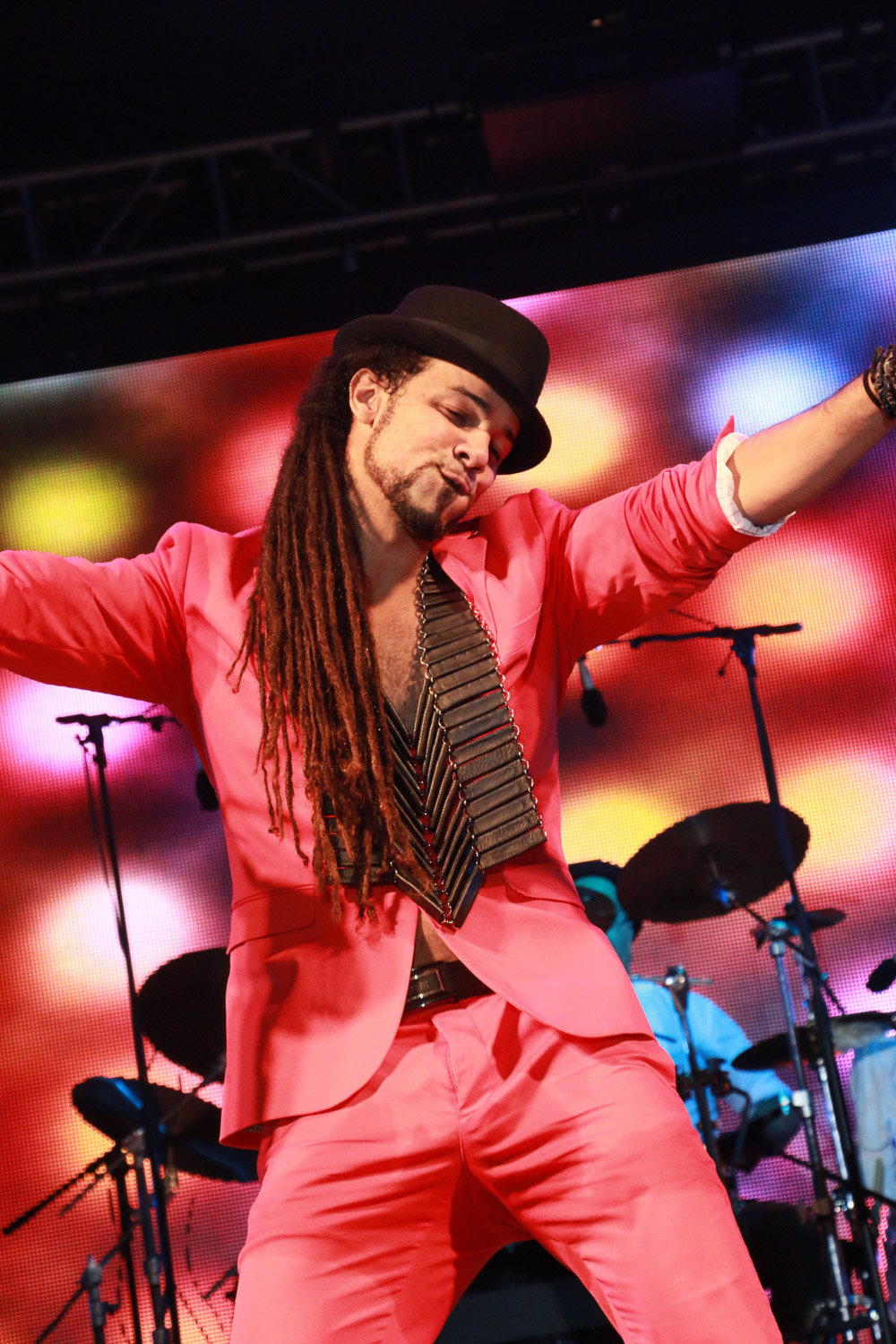 Soca star Kees performs on stage in a red suit. Photo by Ross Photography, Trinidad, W.I..