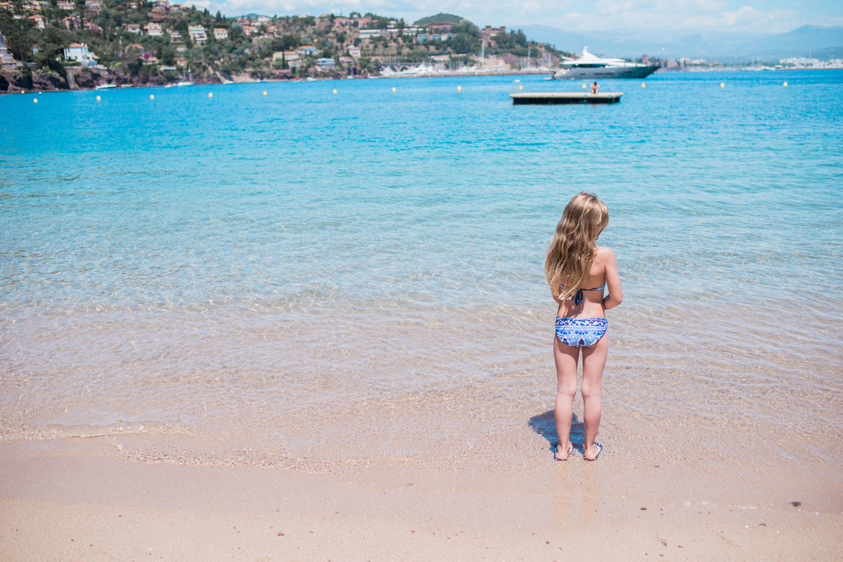 young girl staring at the ocean in france