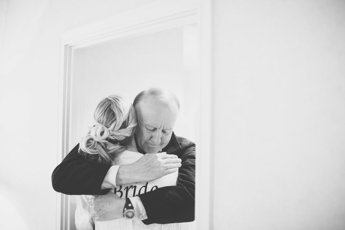 The bride's father give her a hug on the morning of her wedding