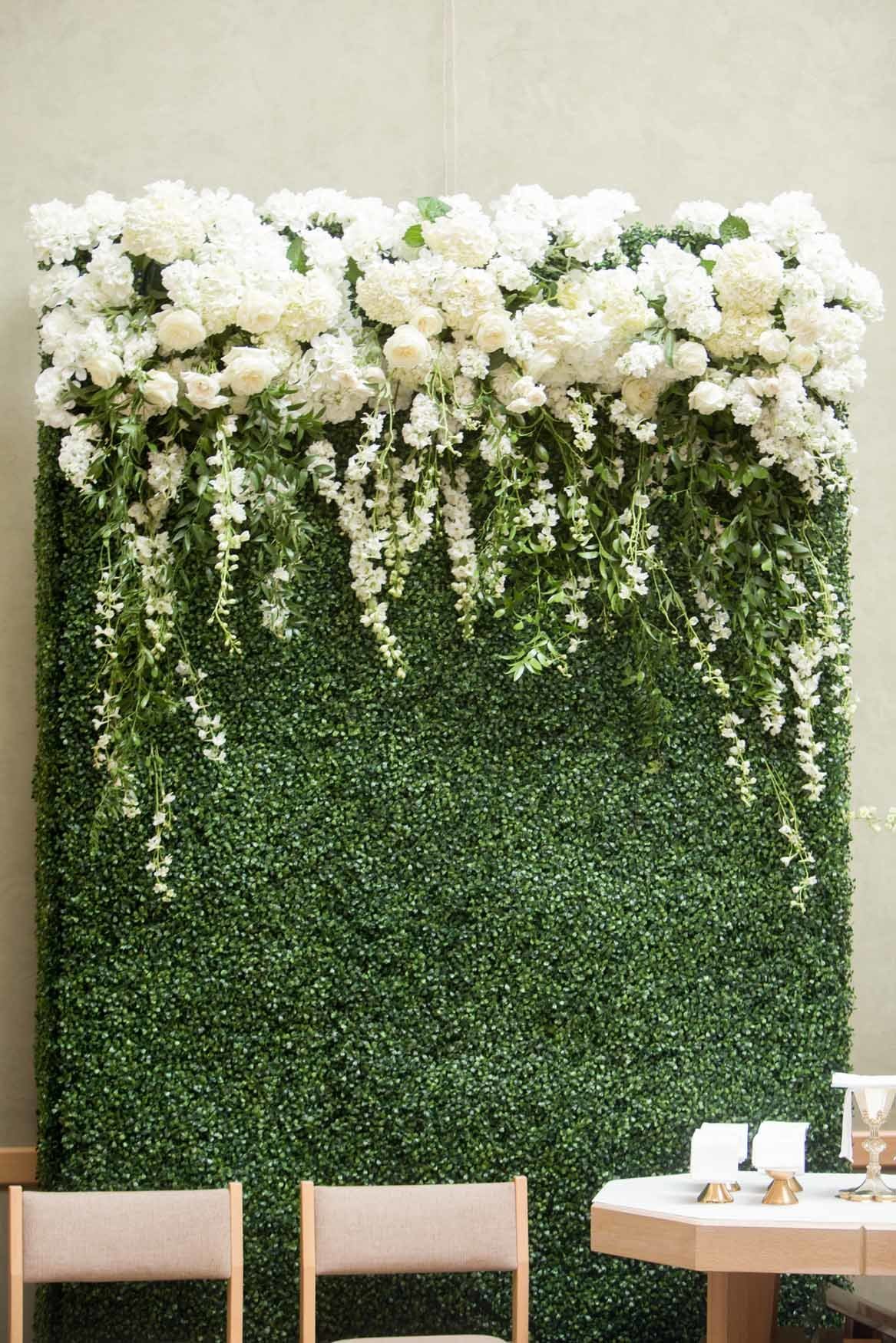 Wedding ceremony alter greenery wall with white flowers