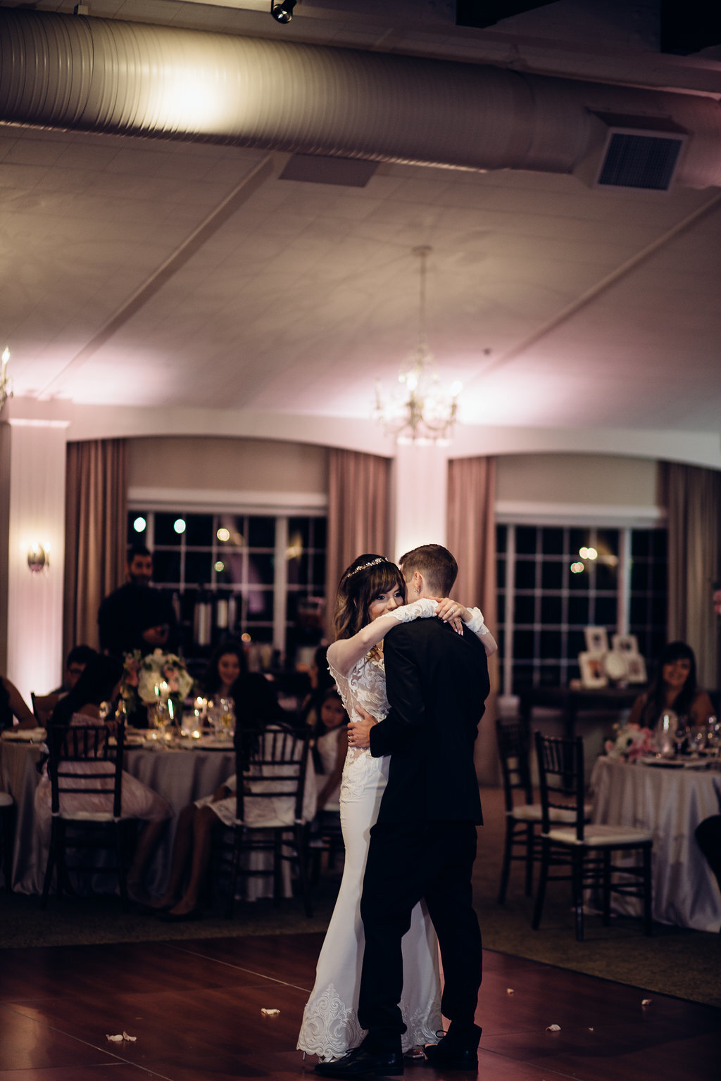 Wedding Photograph Of Bride Holding Her Groom While Dancing Los Angeles
