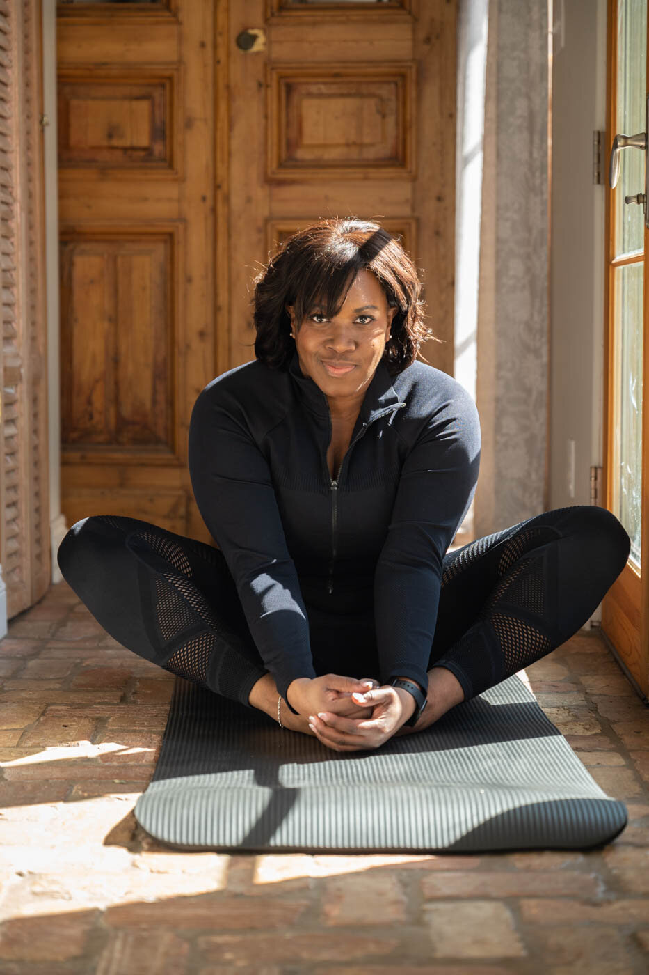 A woman sitting on the floor practicing yoga