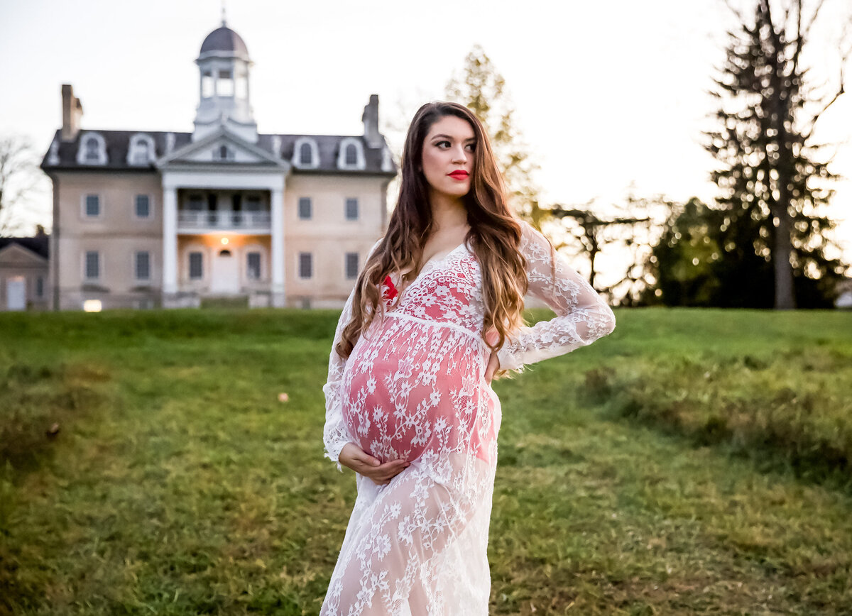 A Baltimore Mom embraces her baby bump during her maternity session at Hampton Mansion in Baltimore County, Maryland