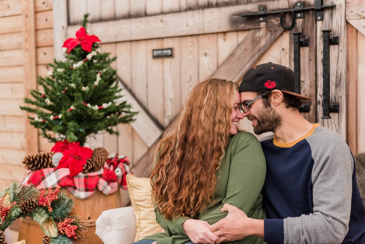 Couple touching foreheads for christmas photos
