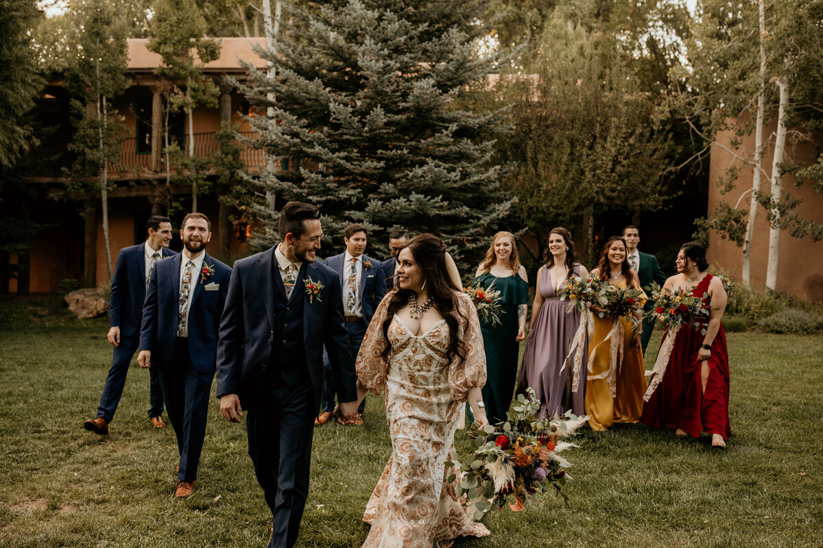 bride and groom walking with wedding party in Taos New Mexico