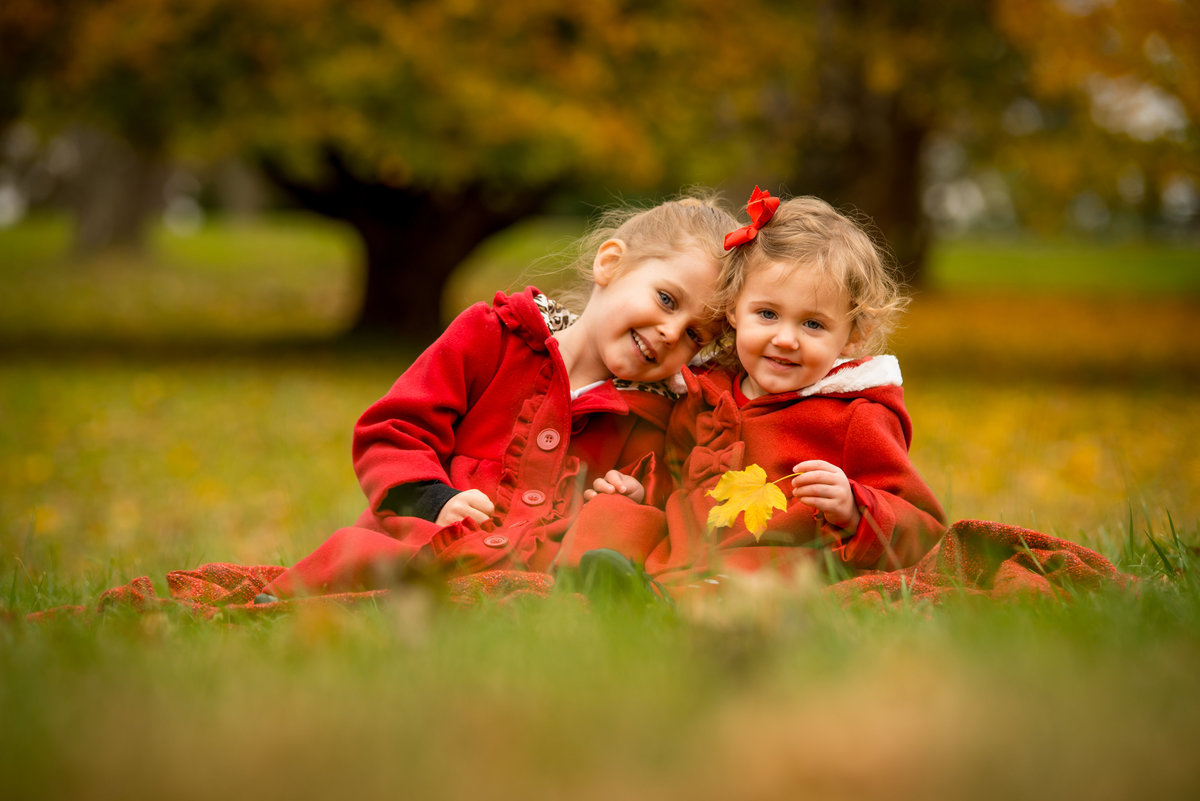 Two sisters enjoy a beautiful outdoor family photo shoot
