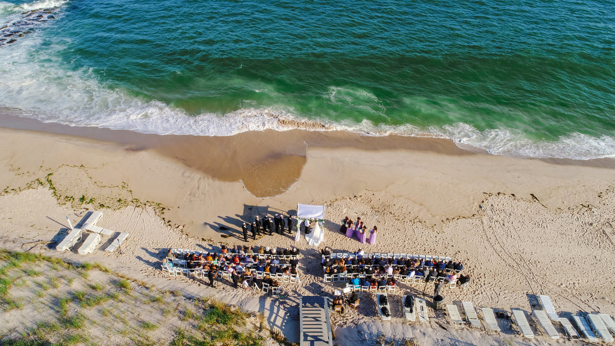 Drone photo of wedding ceremony on the beach at Oceanbleu