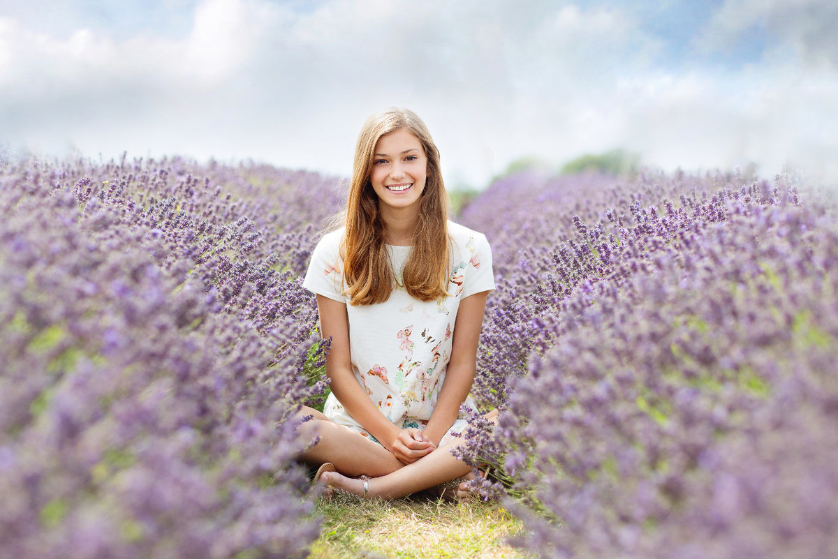 young girl sitting in lavender field