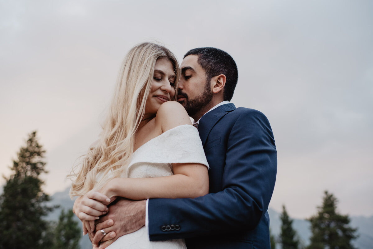 Photographers Jackson Hole capture bride and groom hugging in Jackson Hole