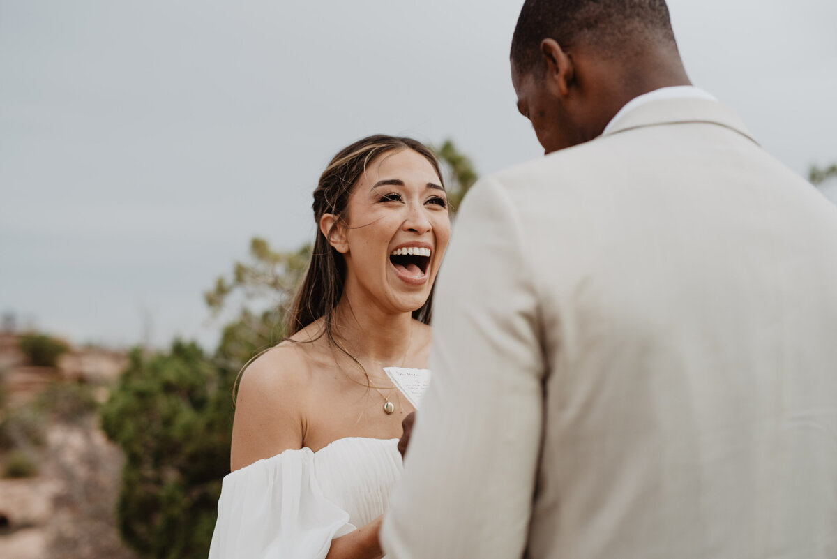 Utah Elopement Photographer captures bride laughing during vows