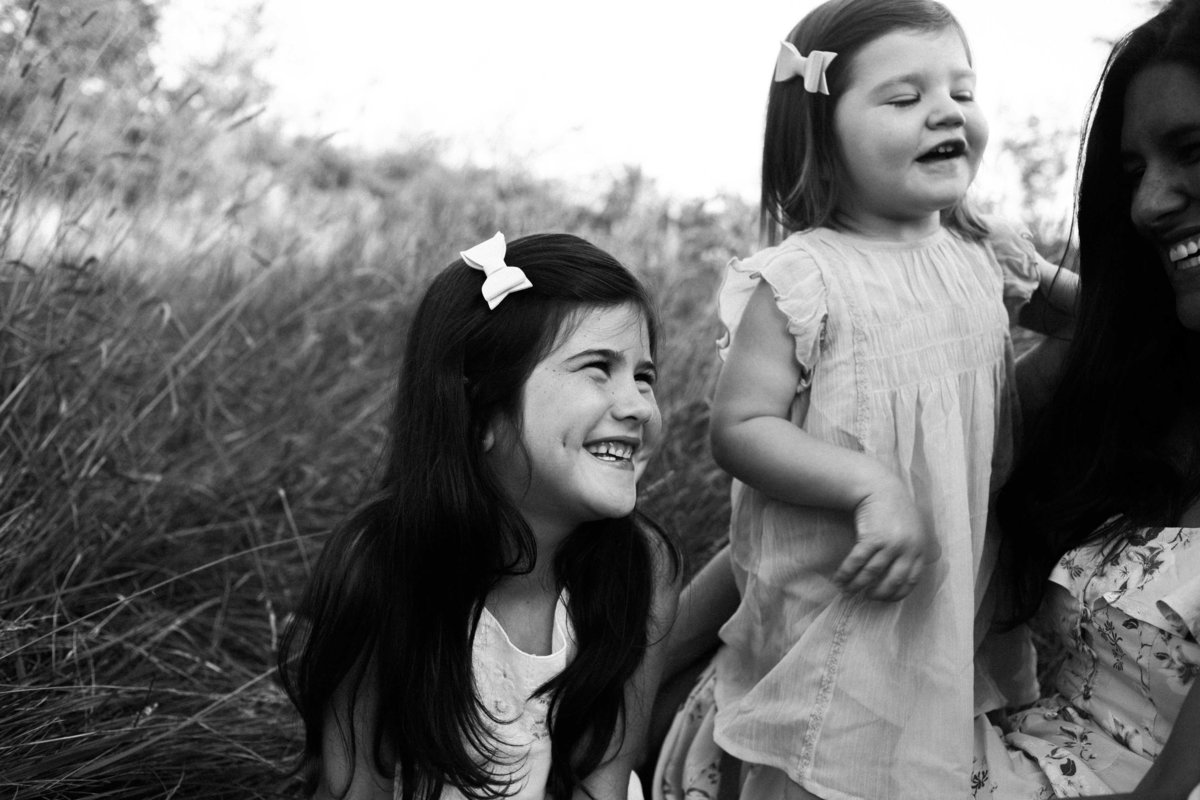 Little girl laughing with mom during sunset session with Elle Baker Photography