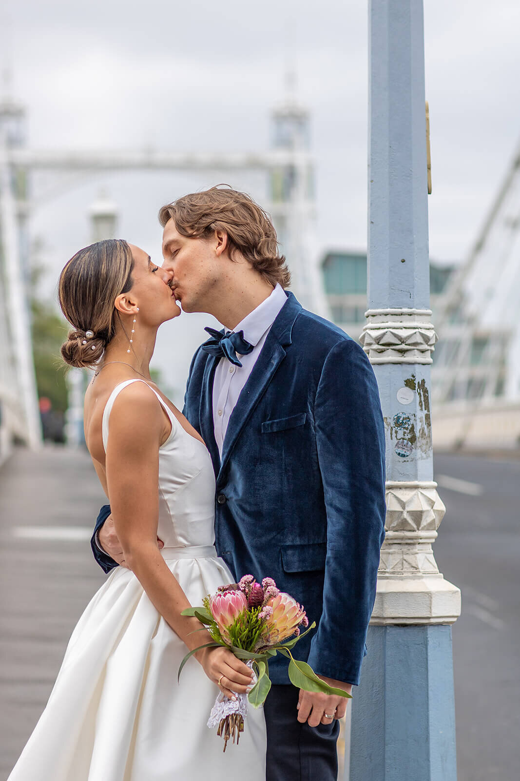 Bride and groom kiss in Chelsea by London wedding photographer Peach Portman