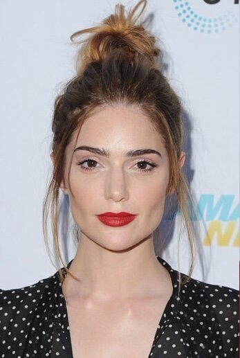 Janet Montgomery wearing her hair up and red lipstick