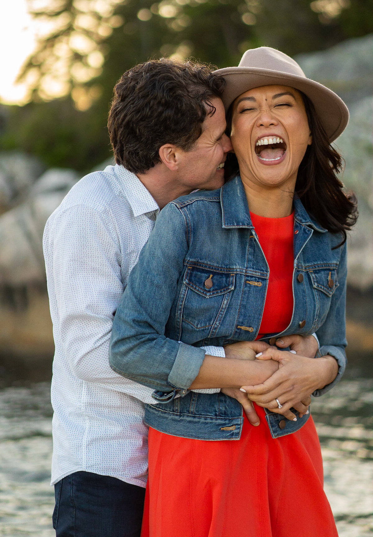 Couple laughing during their Lighthouse Park engagement session
