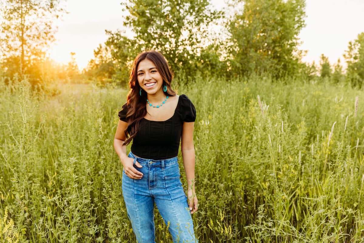 gorgeous brown hair girl standing with hand on hip during her Green Bay senior photo session