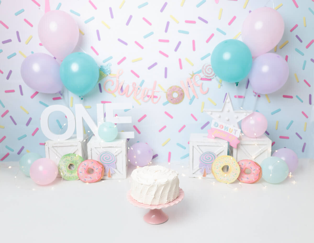 A baby's first cake smash moment captured with donuts in Rochester, NY.