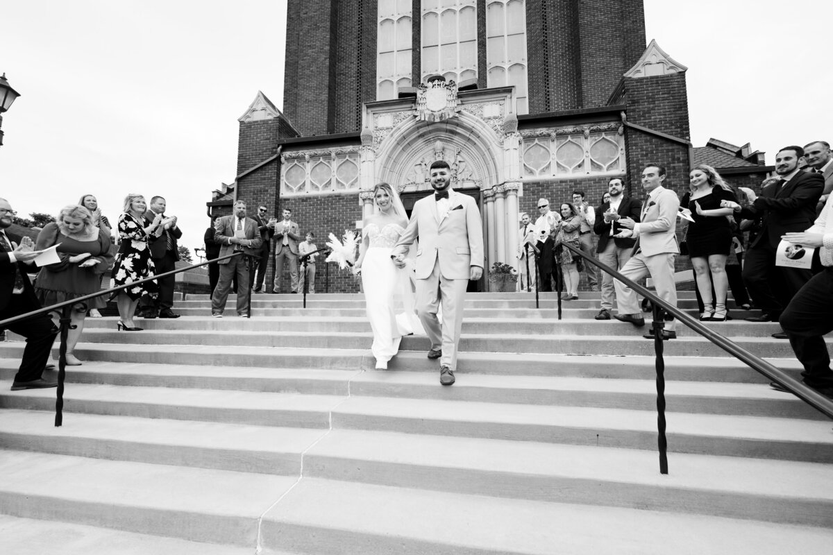 bride and groom happily exit St. Patrick's Church on their wedding day. Photo taken by Aaron Aldhizer