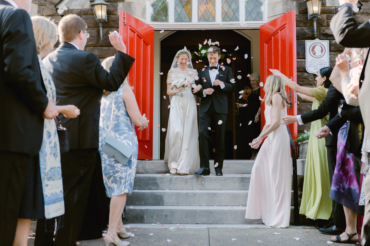 Mo davis photography couple exiting church with rose petals thrown