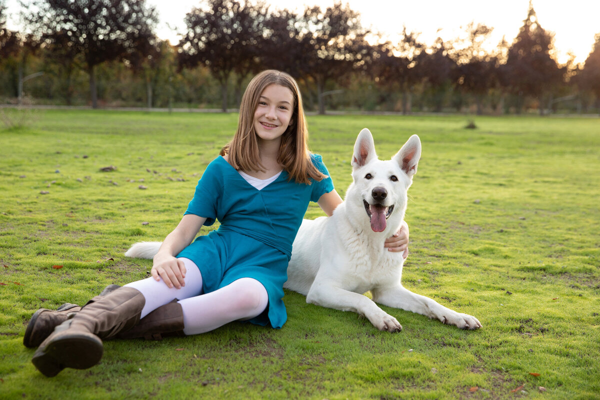 girl with white eskimo dog