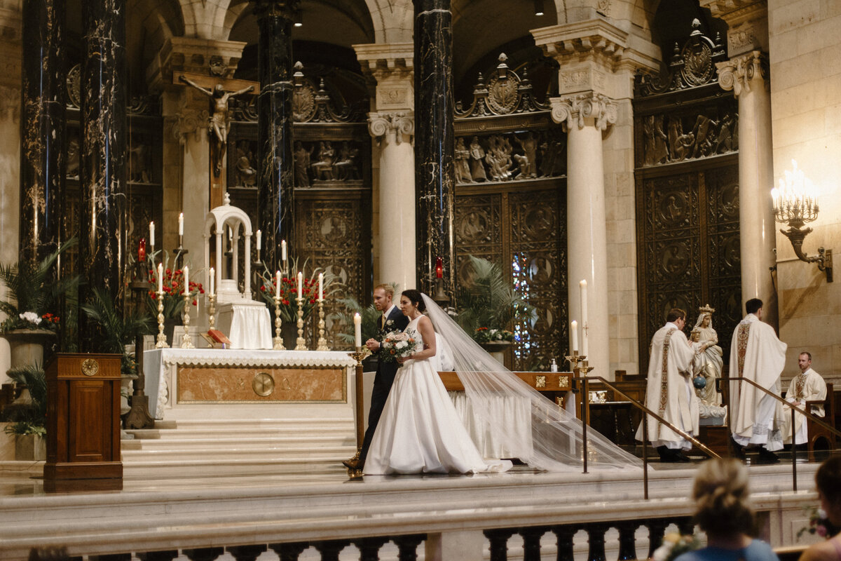 bride and groom walking in a church