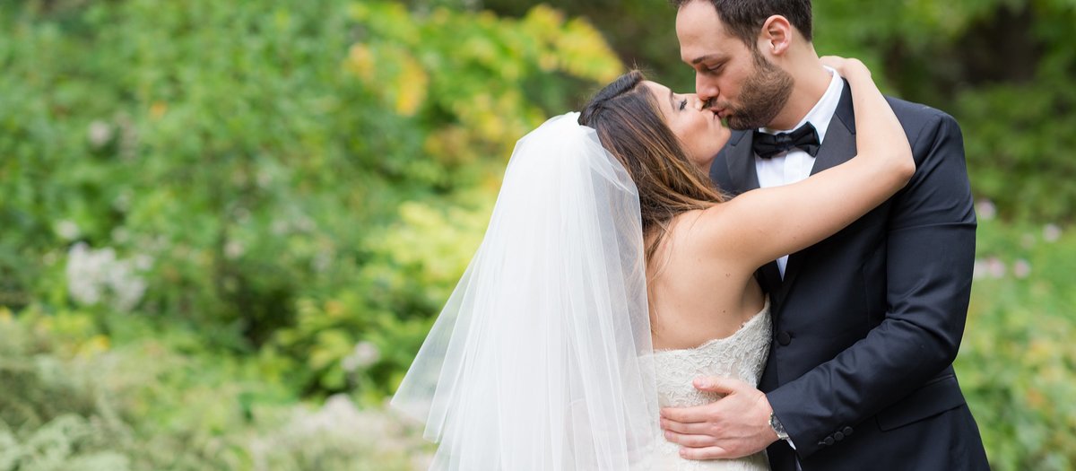 Bride and Groom kissing in Conservatory Garden in Central Park, NYC photo