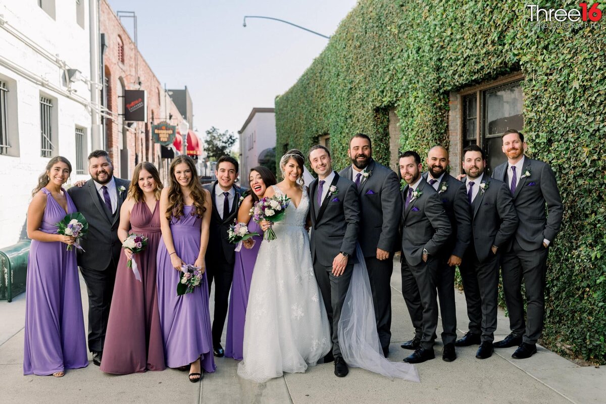 Back alleyway photo pose with Bride and Groom and bridal party