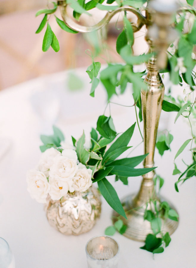 gold chandelier with greenery