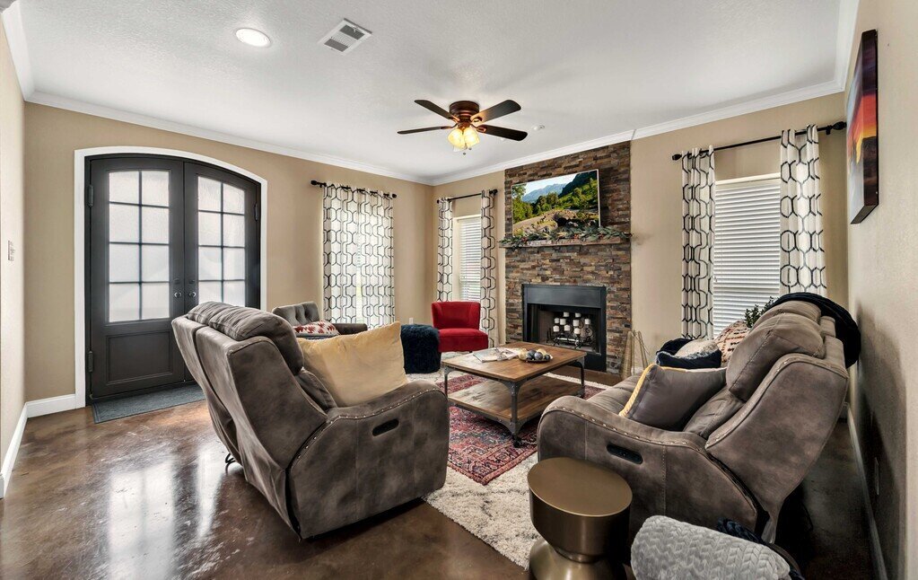 Beautiful living room area with plenty of seating and smart TV in this four-bedroom, four-bathroom vacation rental home and guest house with free WiFi, fully equipped kitchen, firepit and room for 10 in Waco, TX.