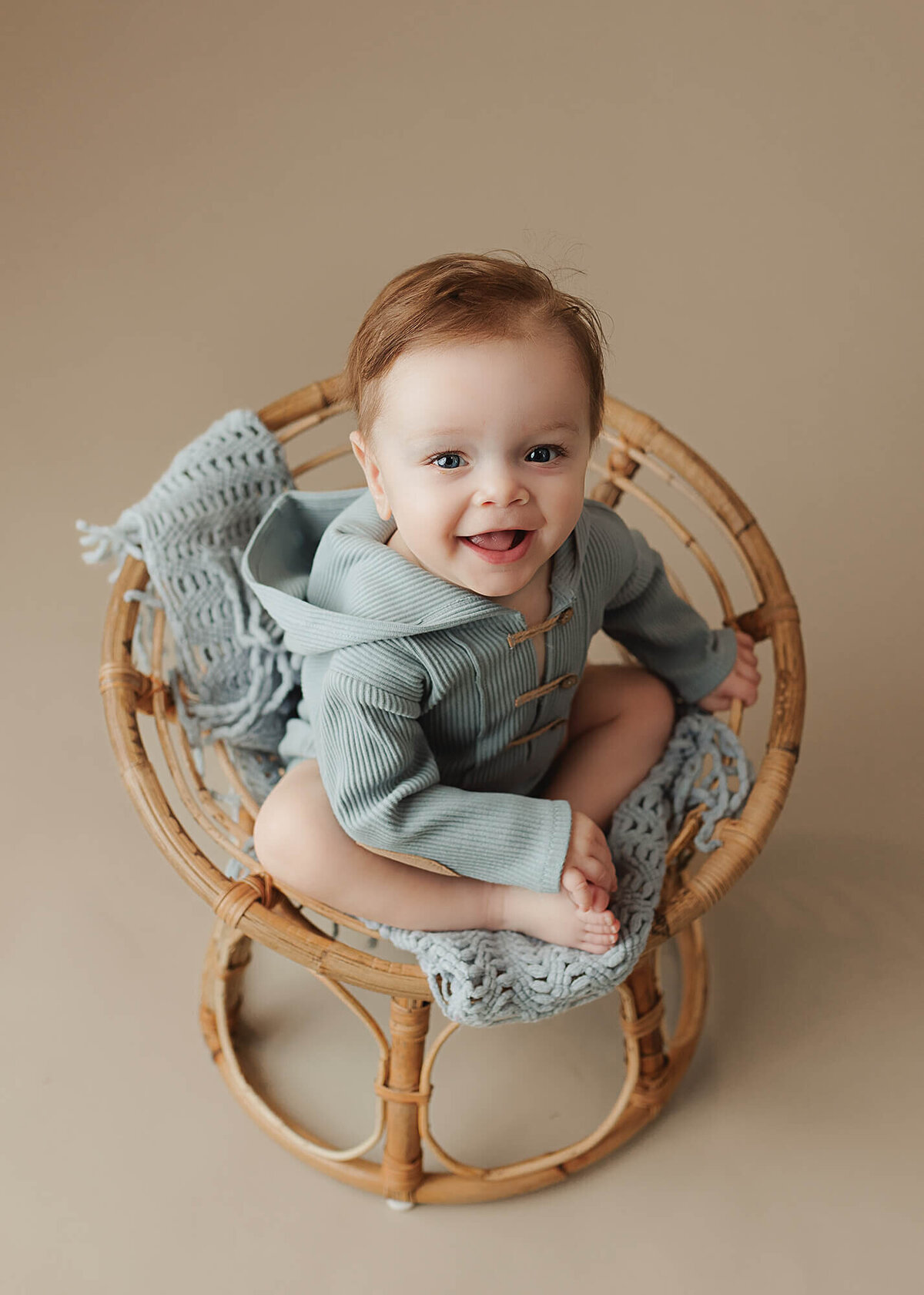 Baby boy smiles for his milestone session at Jennifer Brandes Photography studio.
