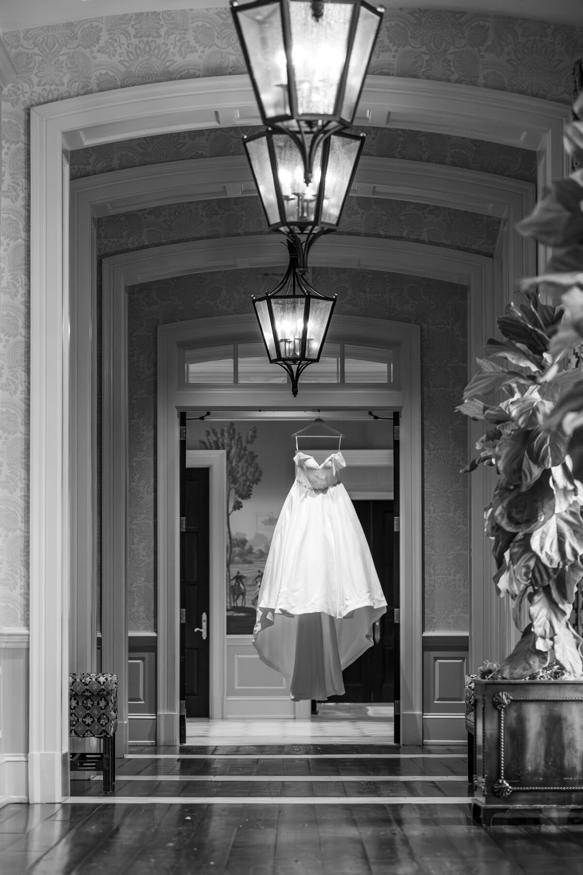 A wedding dress handing in the hallway of the Prestonwood Country Club in Cary by JoLynn Photography, a Raleigh wedding photographer