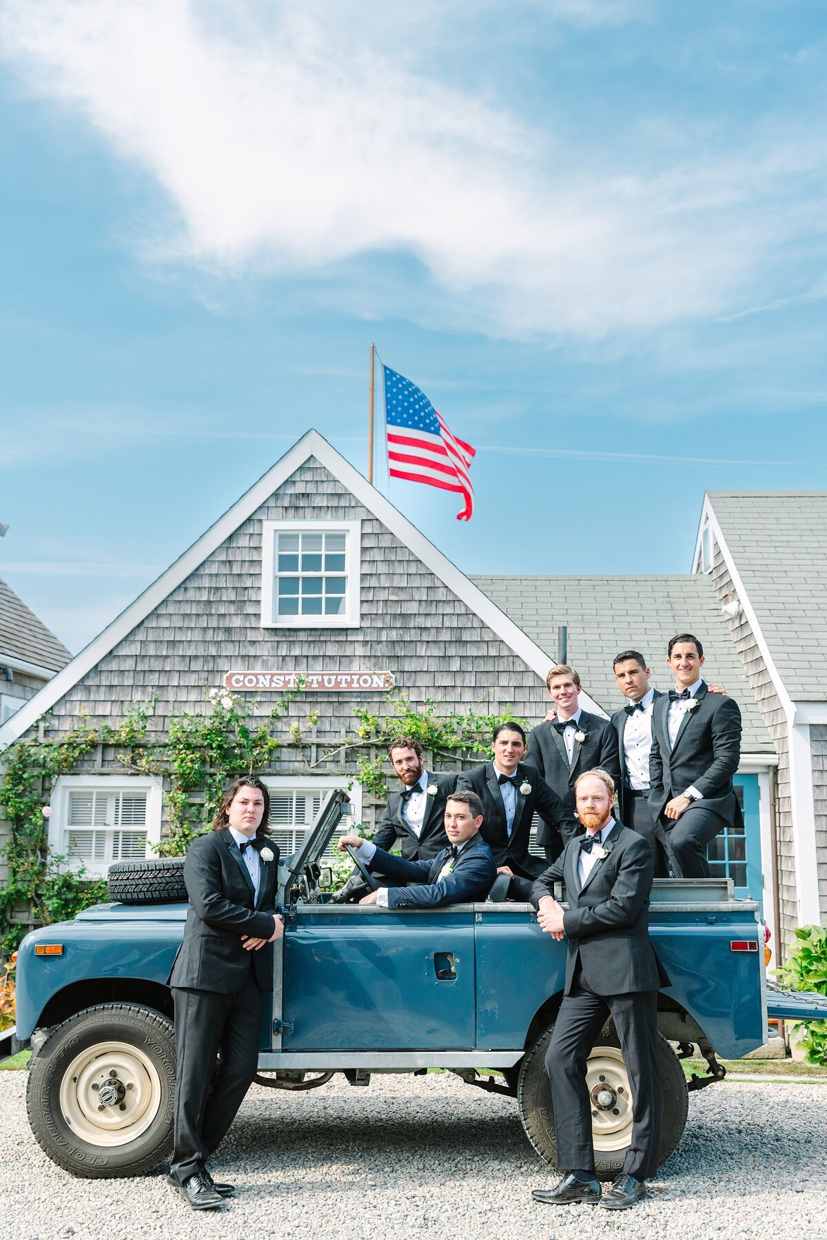 groom and groomsmen in old blue jeep