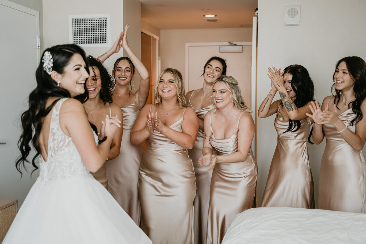bride and bridesmaids first look bridesmaids in champagne sating bridesmaid dresses