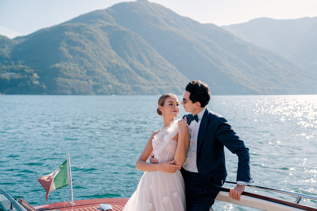 Bride and groom on private boat on lake como, italy