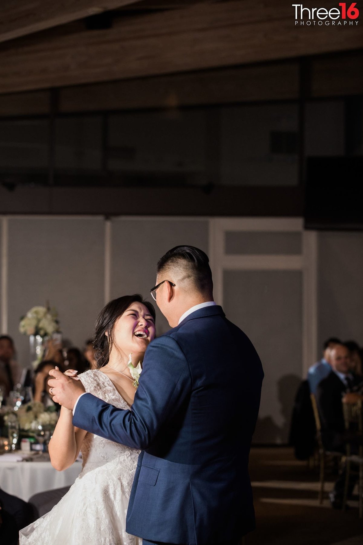 Bride laughs with her Groom during their First Dance