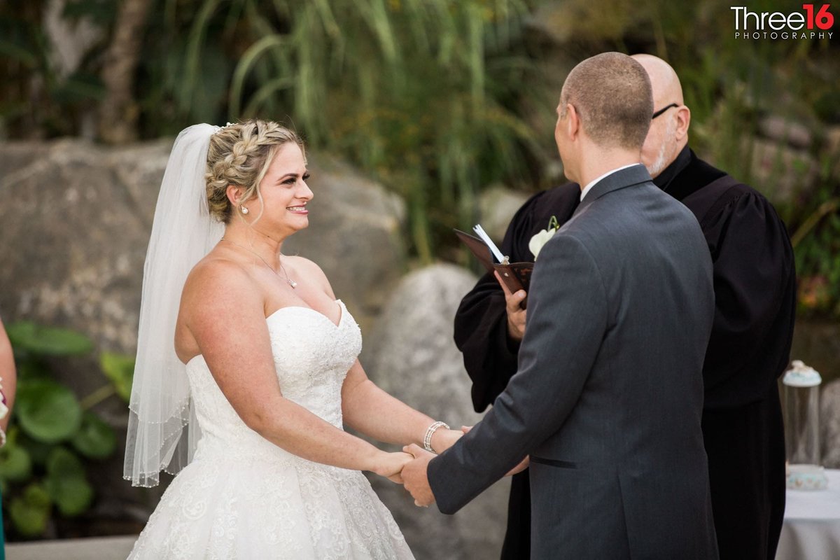 Bride and Groom face each other and hold hands during vows