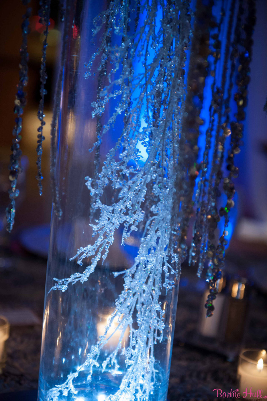 sparkly branches inside glass vase for winter party centerpiece