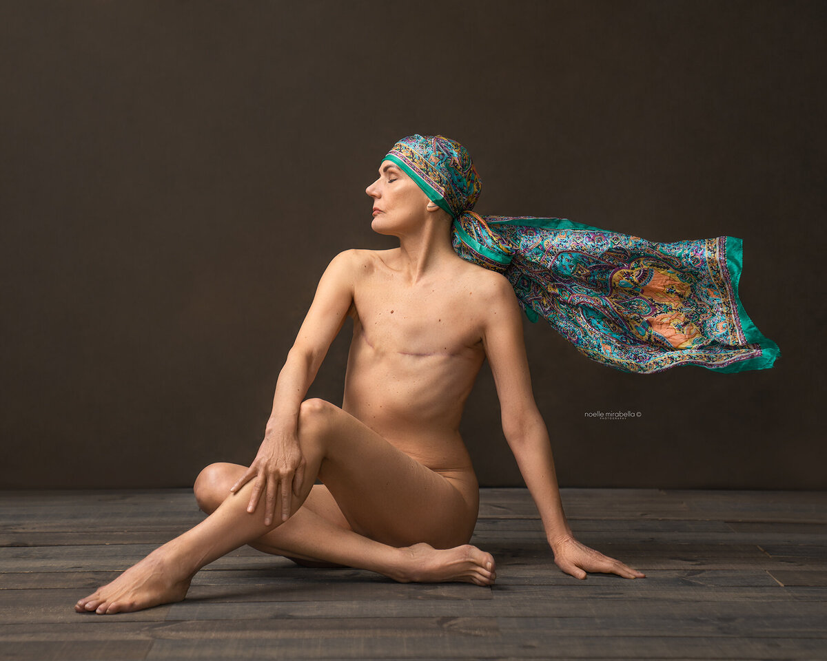 Women in strong pose showing her double mastectomy scars.
