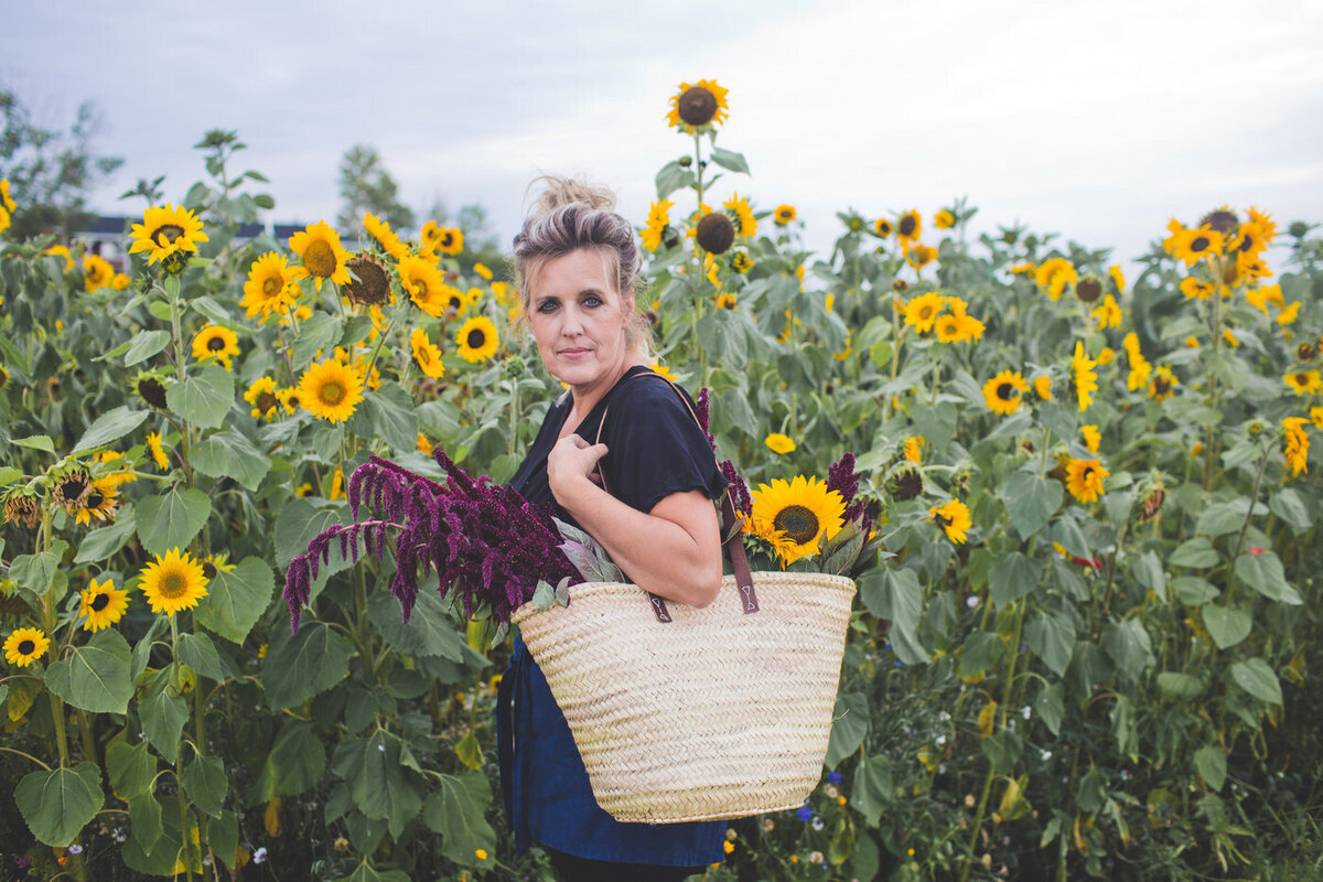 lady standing in a sunflower field