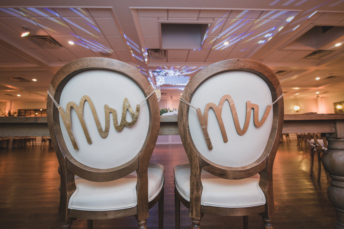 mr. and mrs. back of chair signs photo from wedding reception at The Vineyards at Aquebogue