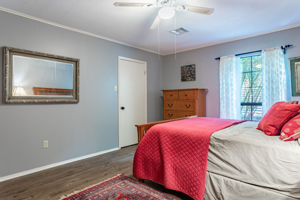 Bedroom with comfortable bedding in this 5-bedroom, 4-bathroom vacation rental house for 16+ guests with pool, free wifi, guesthouse and game room just 20 minutes away from downtown Waco, TX.