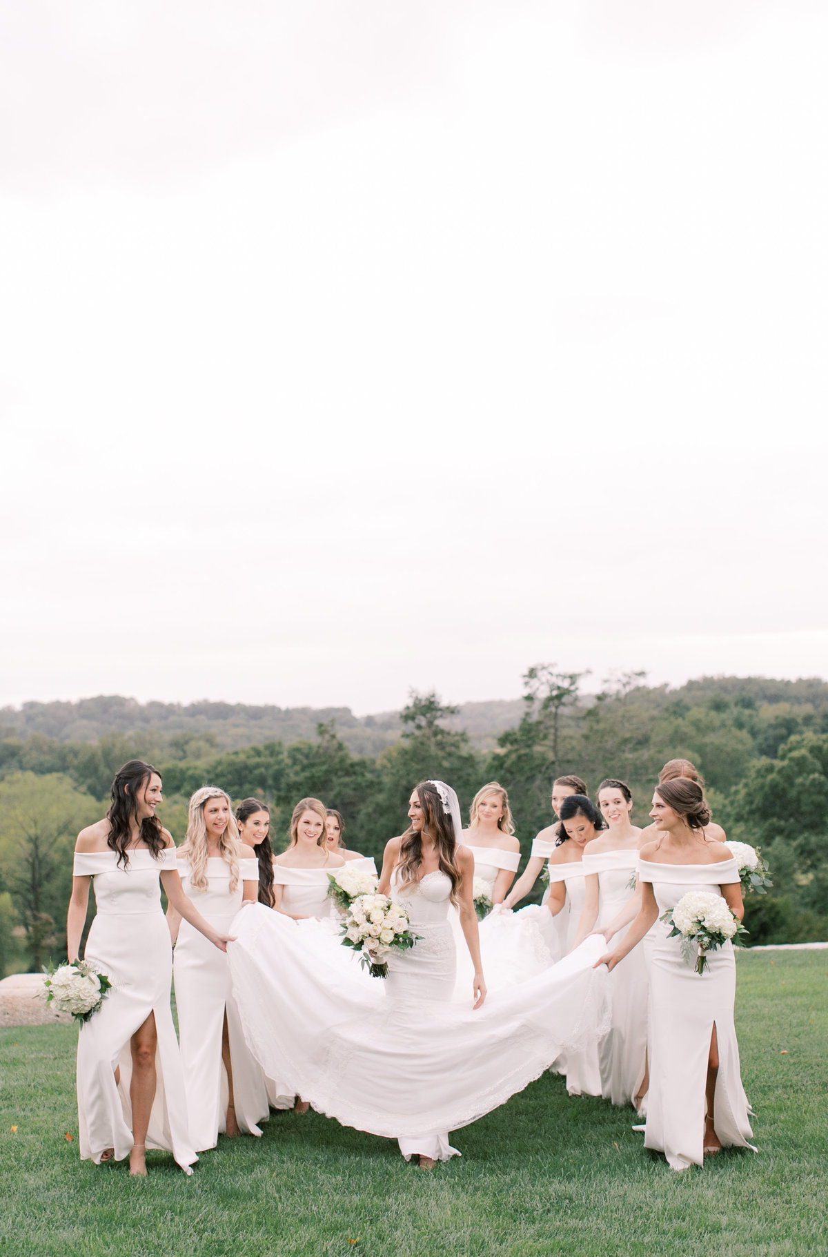bride walking with bridesmaids during outdoor bridal portraits