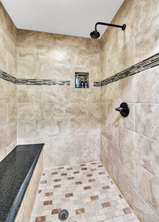 Bathroom with spacious shower in this four-bedroom, four-bathroom vacation rental home and guest house with free WiFi, fully equipped kitchen, firepit and room for 10 in Waco, TX.