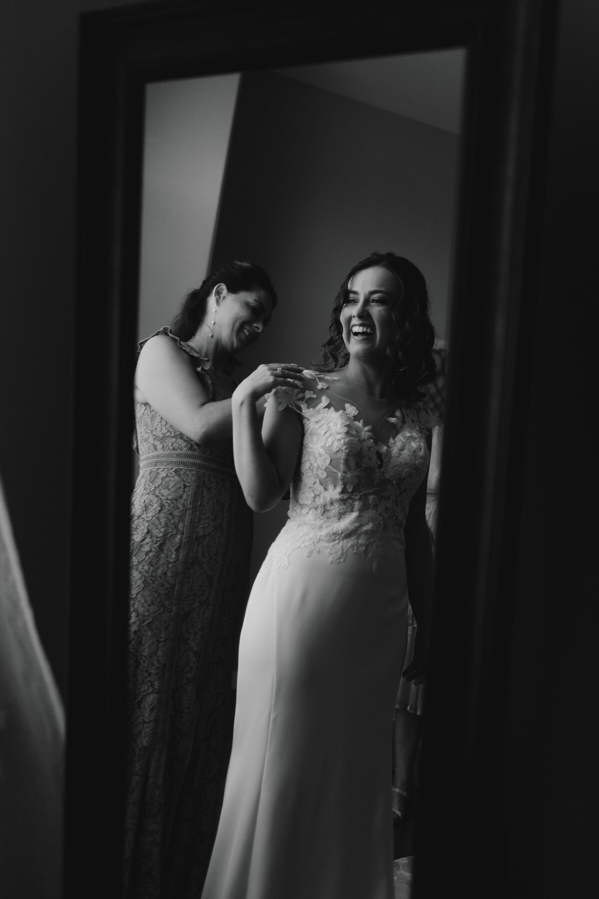 Bride getting ready with Mom in mirror St Catherine of Siena Wedding  | The Axmanns
