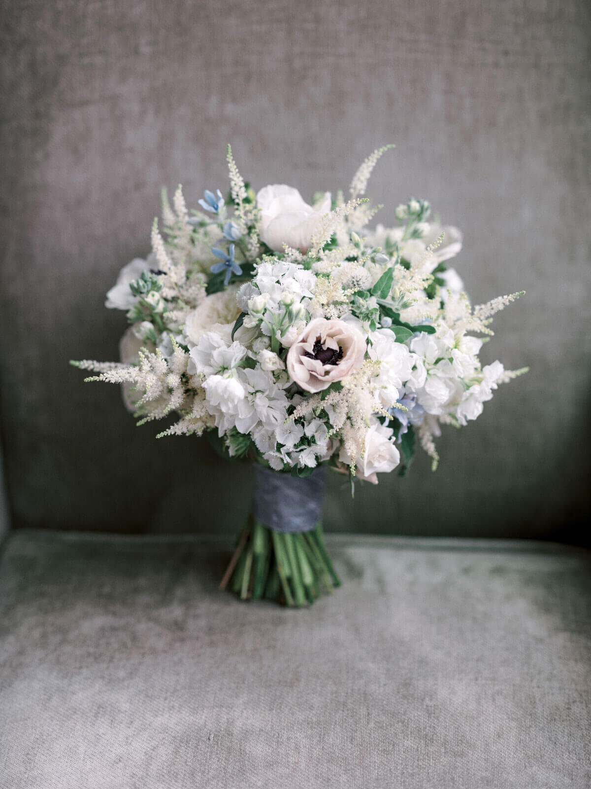 A beautiful bridal bouquet with different white flowers at The Lion Rock Farm, CT. Image by Jenny Fu Studio
